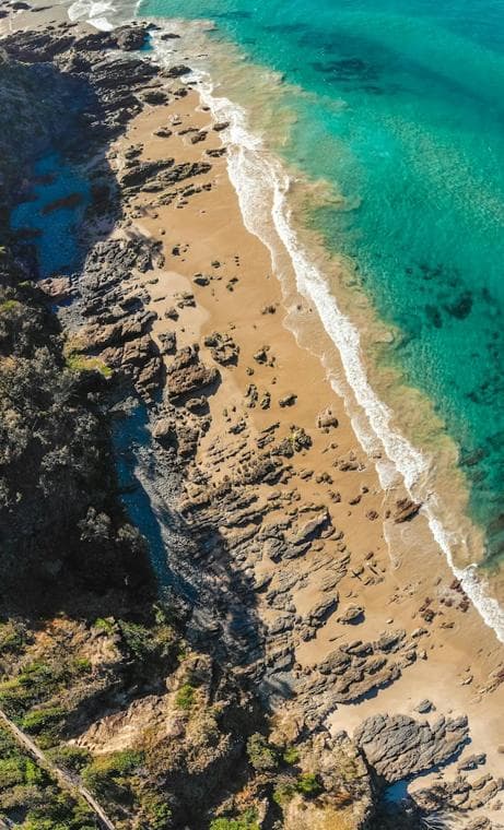 Aerial view of a beach and turquoise coastline