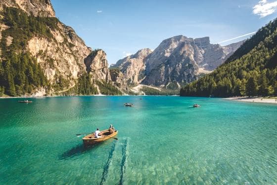 Rowing boat on a turquoise lake in the Dolomites