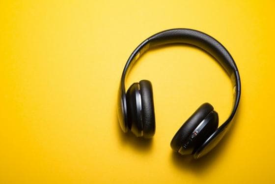 Black headphones on a bright yellow background
