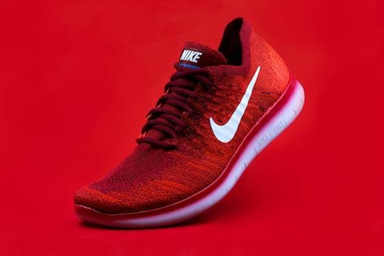Red running shoe product shot on a red background