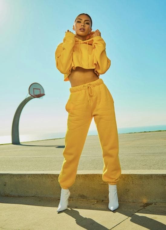 Fashion editorial: yellow tracksuit by a basketball hoop